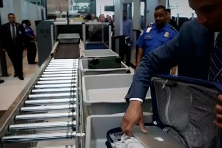 Security officer operating baggage screening equipment in Jaipur